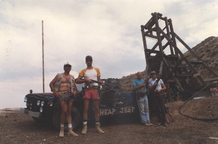 a vertical mine entrance is in the background